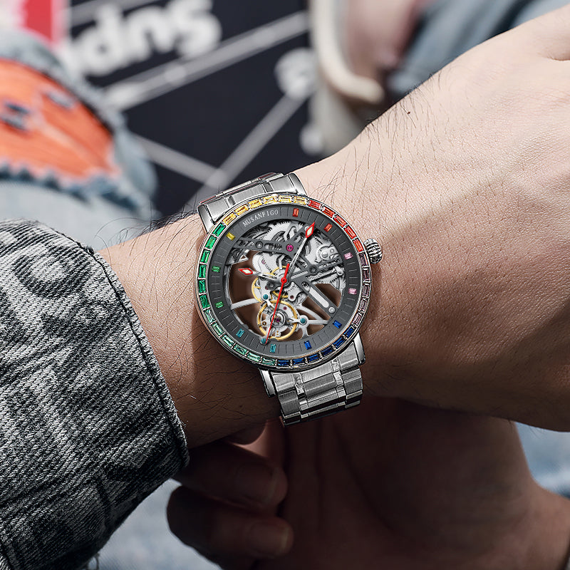 men wearing MUSANFIGO MG01 skeleton watch with rainbow bezel as a luxury timepiece